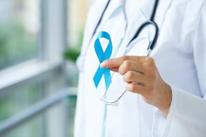 Doctor with blue ribbon, prostate cancer awareness